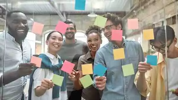 Students brainstorming with sticky notes